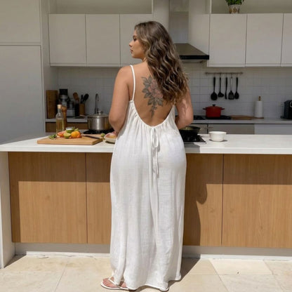 Woman in a white dress kleida  standing in a modern kitchen